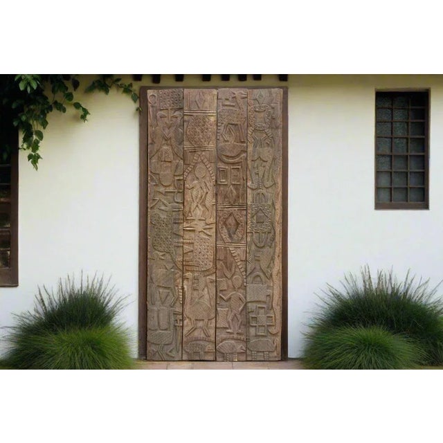 A tapestry of African symbolism, this extraordinary Nupe carved door panel is a rare and captivating piece of African...