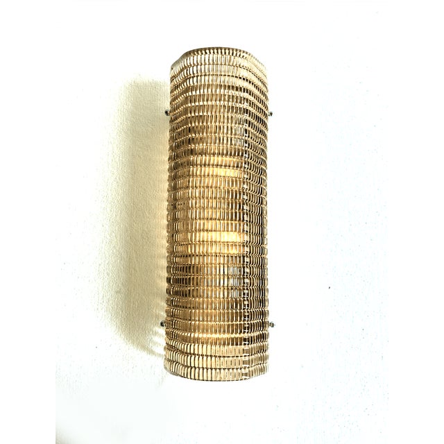 Contemporary wall sconce made in smoked Murano glass with a modern texture that give it bright . Made with a traditional...
