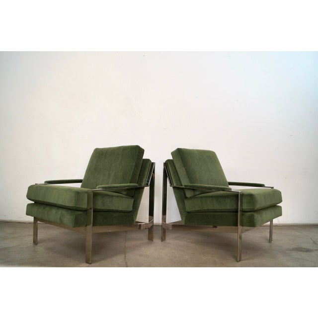 Pair of Mid century Modern style lounge chairs for sale. These have a polished nickel frame, and have been professionally...