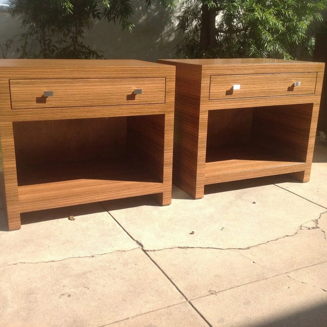 These Mid-century-style nightstands are composed of a chic zebrawood wood veneer that features a striated wood grain. Each...