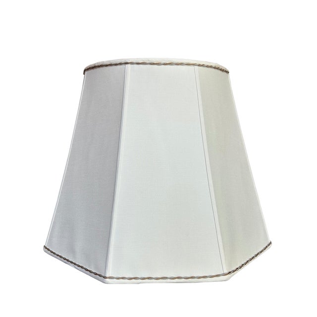 Pair of lampshades out of ivory pongee silk with a bronze and silver twisted silk cord on the top and bottom. Created by...