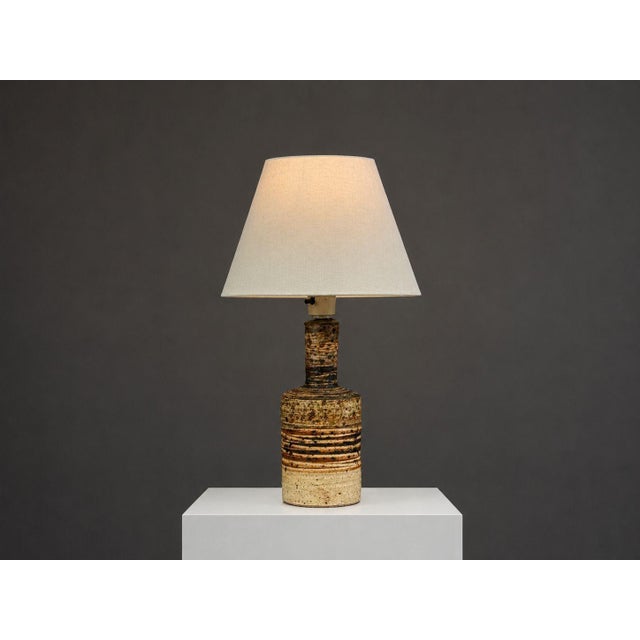 Tue Poulsen, Danish Mid-Century Modern, Table Lamp, Beige Ceramic, Denmark, 1950s A partially glazed stoneware table lamp...