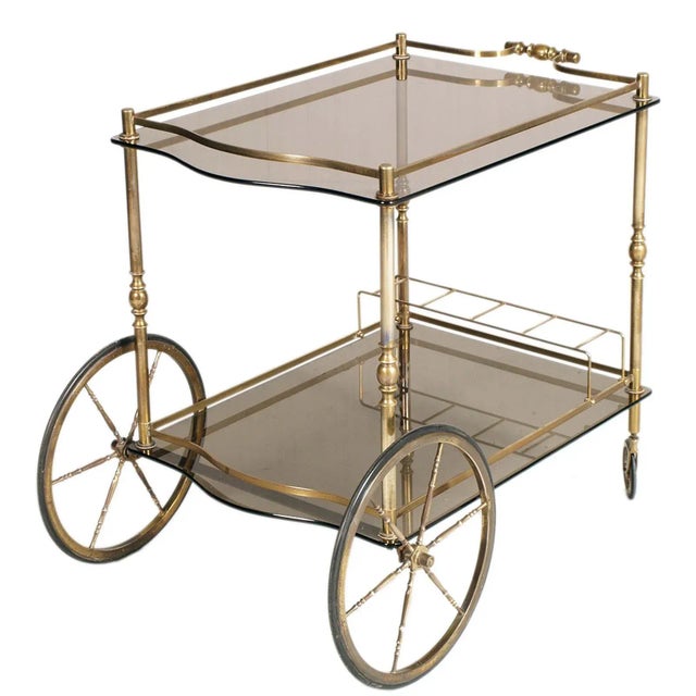 Aldo Tura bar cart designed for the Danieli hotel in Venice in the 1950s. This golden brass cart with smoke glass tops...