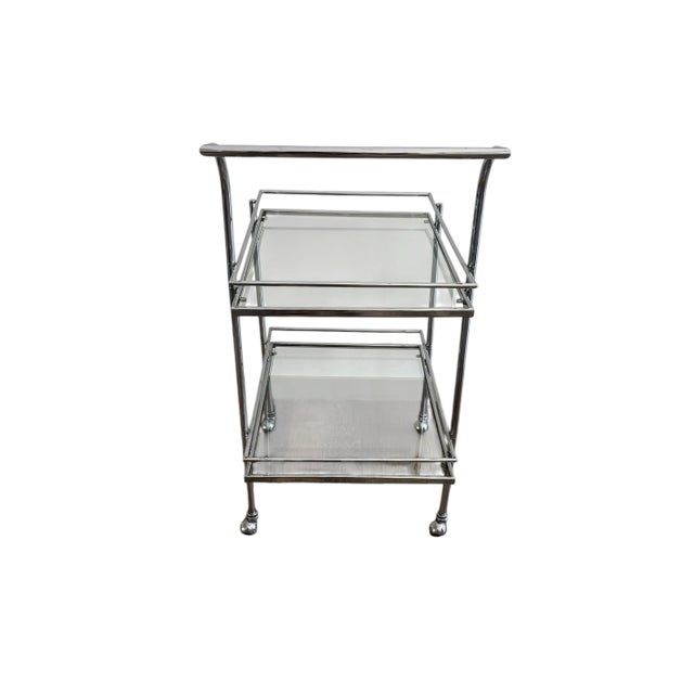 Classic and timeless chrome and glass bar cart. Two levels with each featuring a rail to keep items inside. Chrome casters...