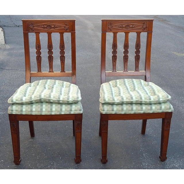 A magnificent pair of French Empire Carved Mahogany with Green and Beige Tufted Upholstered Seat Side Chairs. The chest...