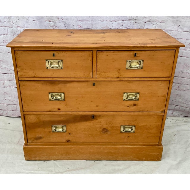 19th Century Pine Campaign Chest of Drawers. Chest features two top drawers fitted with recessed brass bail handles, with...