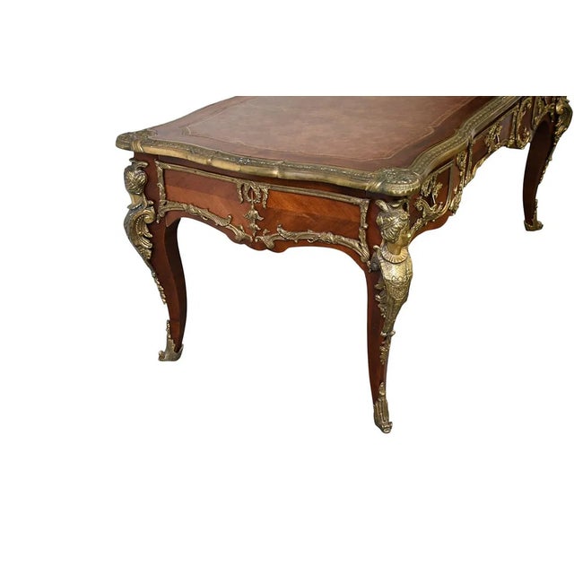 This 20th-century French bureau plat, or writing desk, features a leather top and antique brass handles, adding a touch of...