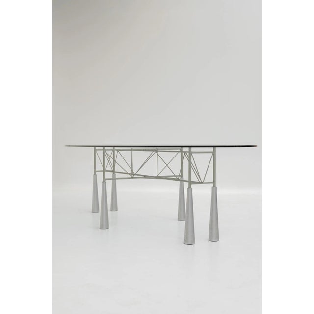Hydra table designed by Elliott Littman and produced by Driade. Large oval glass top resting on a gray lacquered metal...