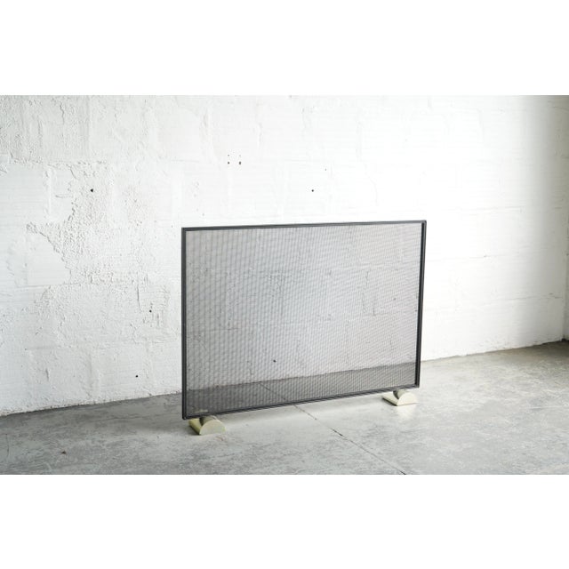 Classy and functional - this fireplace cover is made of steel with copper half circle feet.