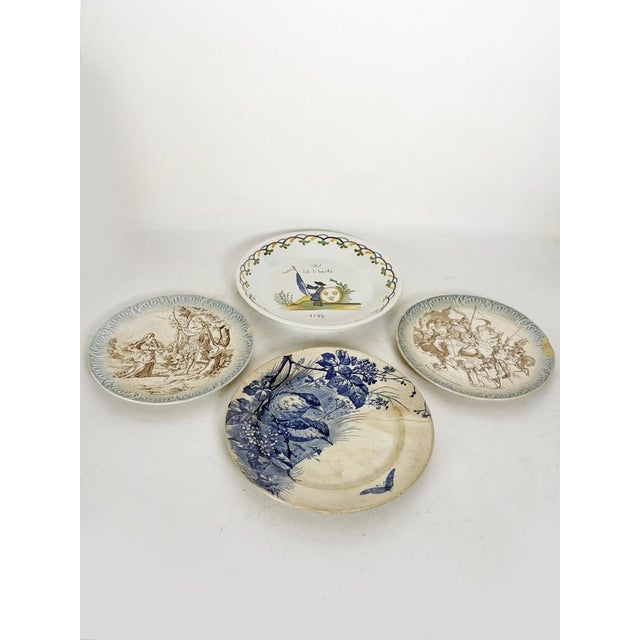 A charming set of four antique earthenware and porcelain plates, each decorated with different illustrations. The designs...