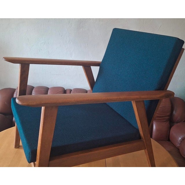 Lounge chair in teak manufactured in Denmark during the 1960s. The cushions have been re-covered with a structured sea...