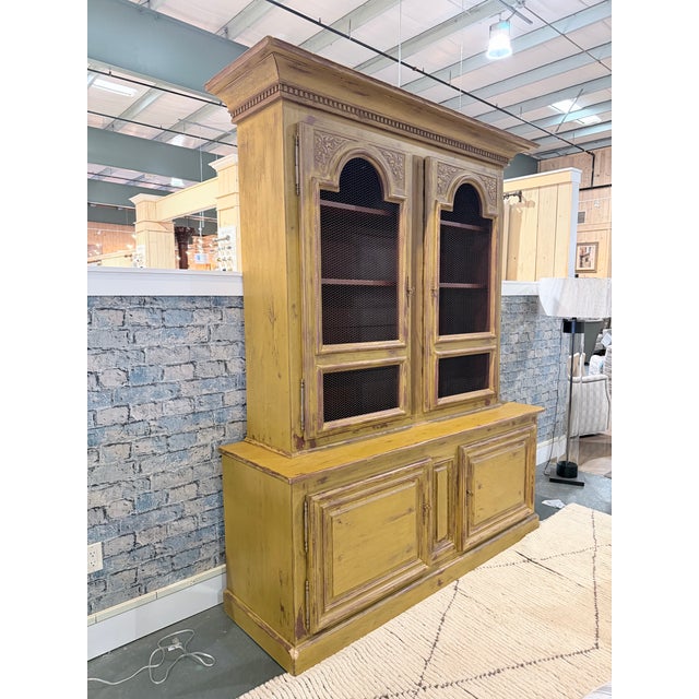 Vintage farmhouse hutch cabinet with a two piece construction featuring an upper display cabinet and lower storage base....