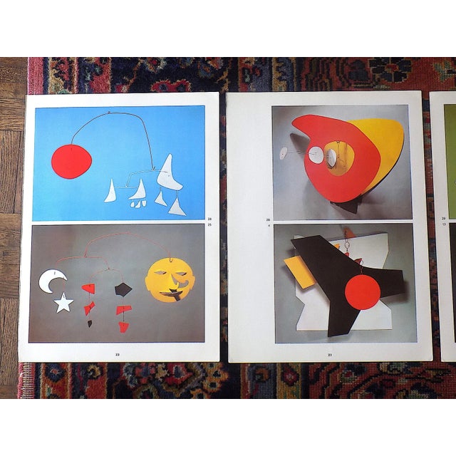 These three vibrant color photographic prints depict several of American artist Alexander Calders 20th century mobiles and...