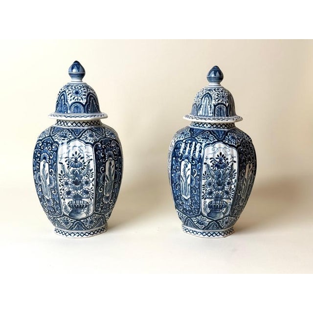 Exceptional matching pair of large blue and white lidded faience vases by tichelaar makkum, friesland, netherlands, dating...