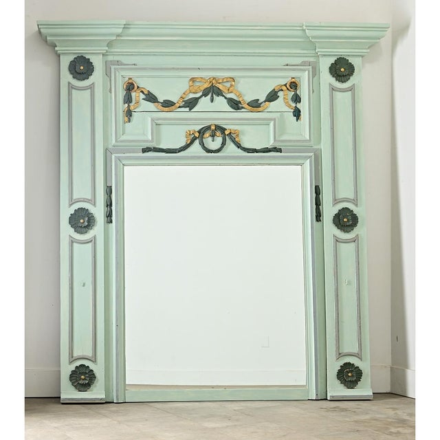 A spectacular Louis XVI style 19th century trumeau in a refreshing mint-green painted finish over carved and giltwood...