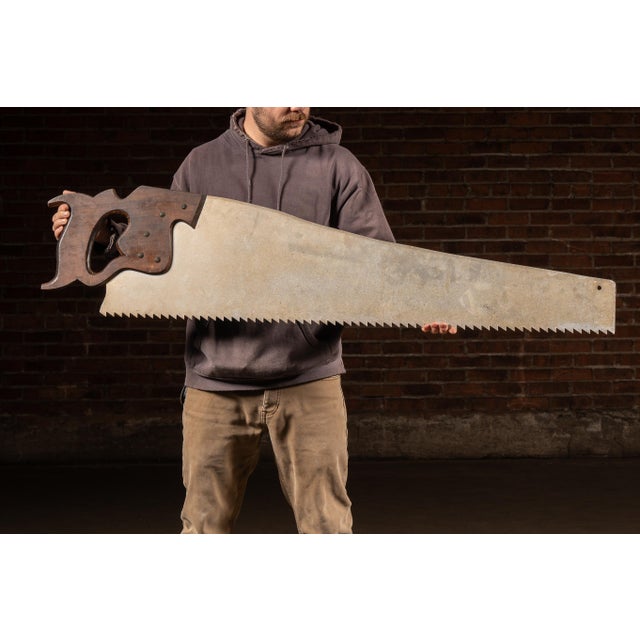 Oversized antique trade sign modeled after a traditional carpenter's hand saw and advertising the “Spearior” line of...