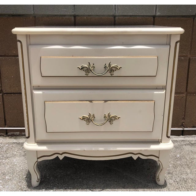 Wonderful vintage French Provincial ivory and gold wood side/end table or nightstand. Features two dressers for plenty of...
