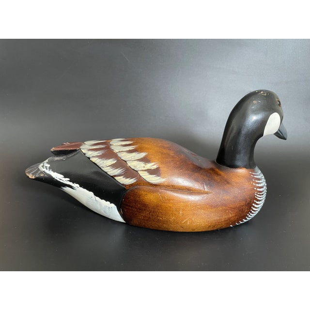 A Mid-Century large wood Canada goose decoy. Hand carved and hand painted with nice details. Glass eyes. Unmarked. Good...