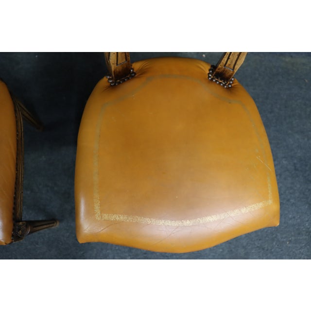 Set of four Louis XVI style side chairs attributed to Maitland-Smith, featuring gilt and distressed painted wood frames,...