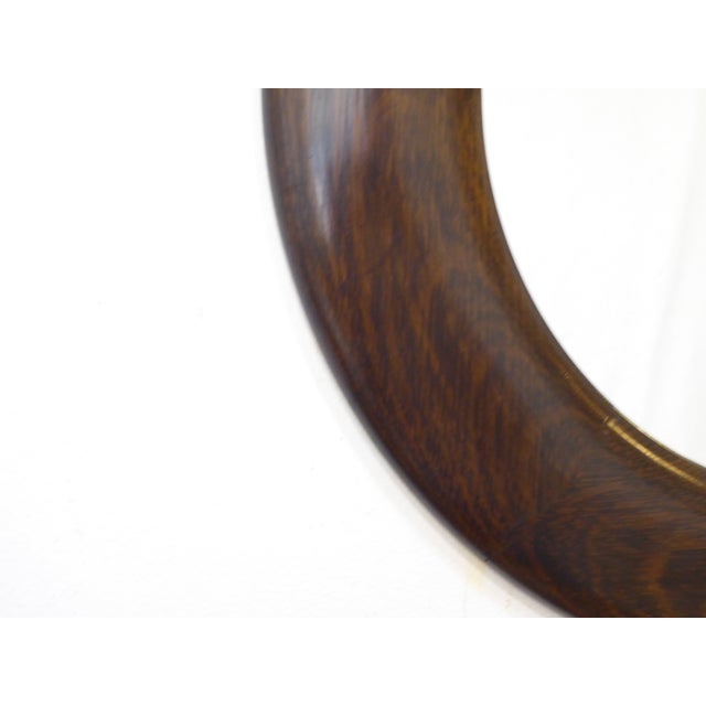 This 19th Century polished wood round mirror is 24" diameter.