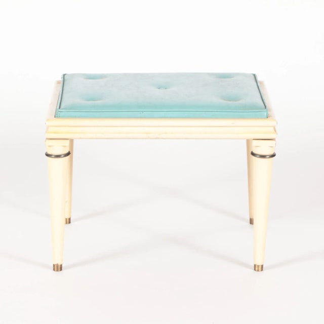 A pair of painted wood and upholstered foot stools with brass mounts in the manner of Arbus. C 1950.