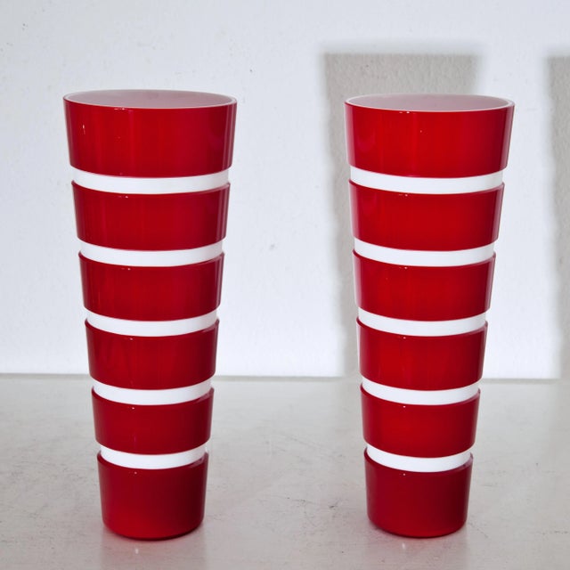 conical glass vase with opaque white glass with horizontal grooves decor and red overlay.