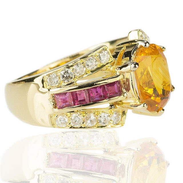 18k Ring with 1.86 carat gold sapphire and 0.82 carats of rubies and 0.32 carats of round diamonds. 6.57 grams 4.25