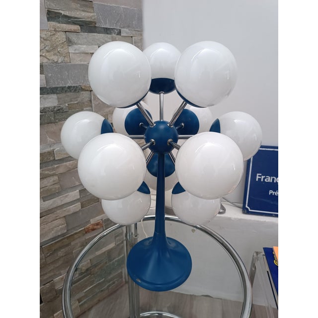 Magnificent Sputnik Space Age table lamp. 1970s. Blue lacquered metal frame. At the center is a metal sphere resembling an...