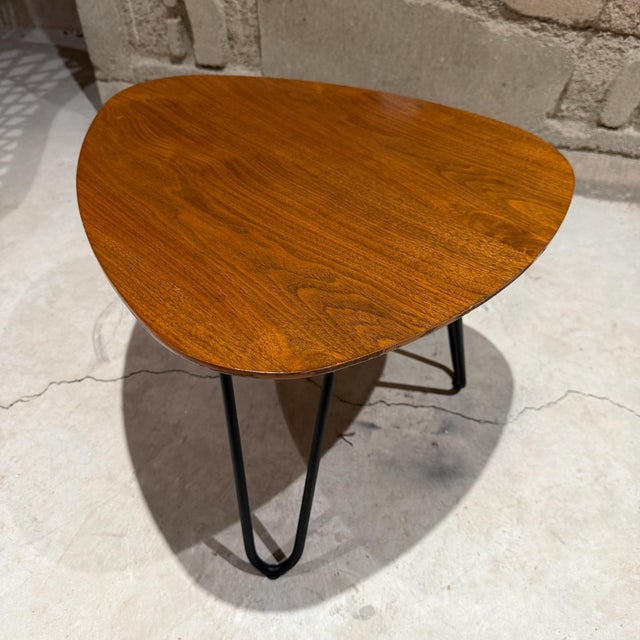 For your consideration, a Mid-Century Modern "Guitar Pick" coffee table, characterized by its rounded triangular top and...