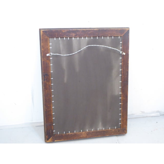 This silverleaf mirror has a dark, rubbed patina.