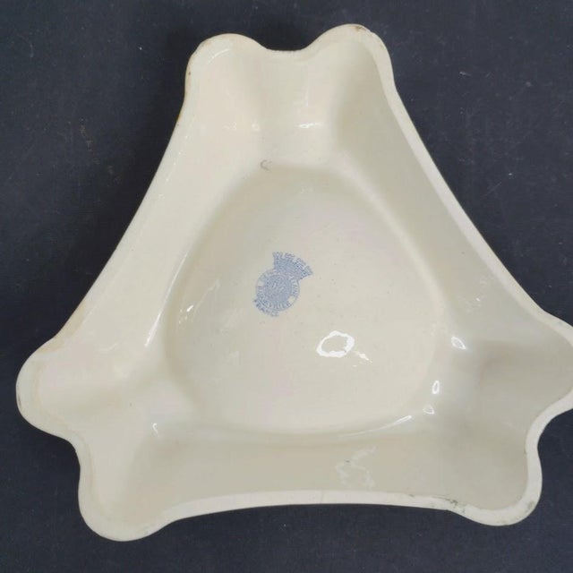 Advertising Ashtray for Martini Aperitif This three-lobed ashtray exemplifies Mid 20th Century promotional ceramics...