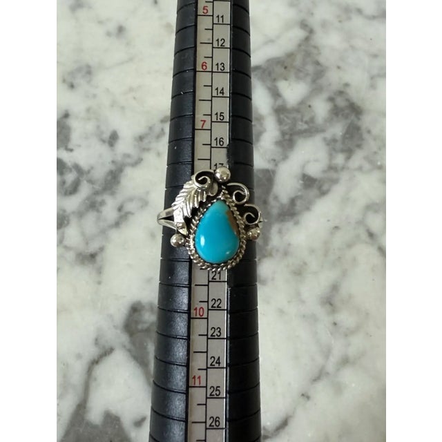 Lovely vintage turquoise and sterling silver Native American ring. The turquoise stone is pear shaped surrounded by...