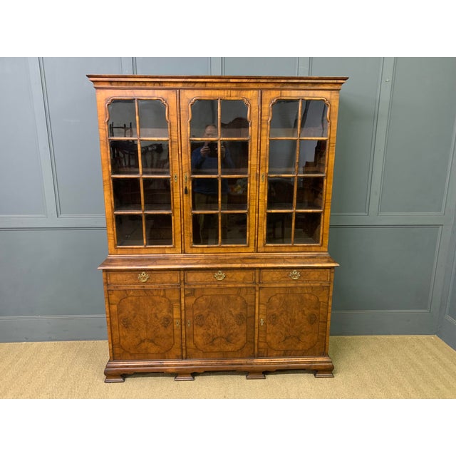 A lovely early 20th century bookcase by Waring & Gillow. In the queen Anne style and very well constructed in solid walnut...