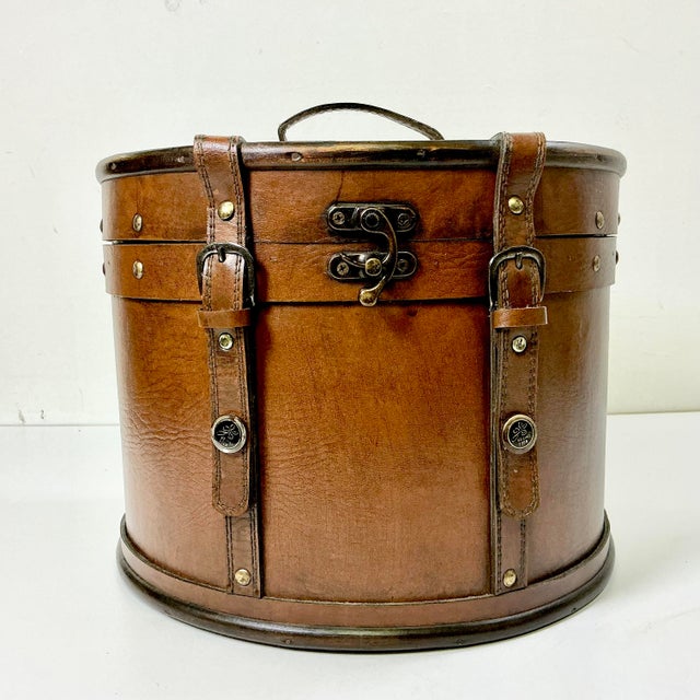 This striking faux leather storage box features classic design and style in the manner of Ralph Lauren. Its rustic style...