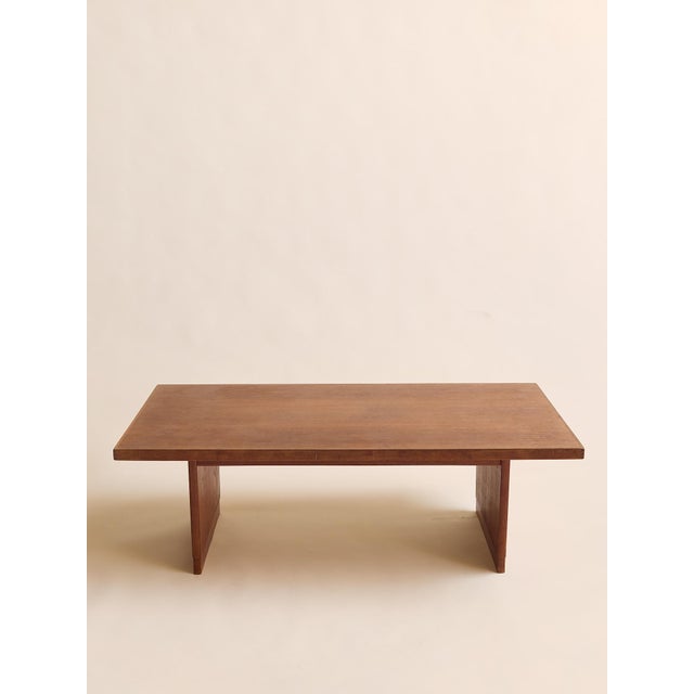 This vintage Mid-Century Modern walnut coffee table features a clean, architectural silhouette with a generously scaled...