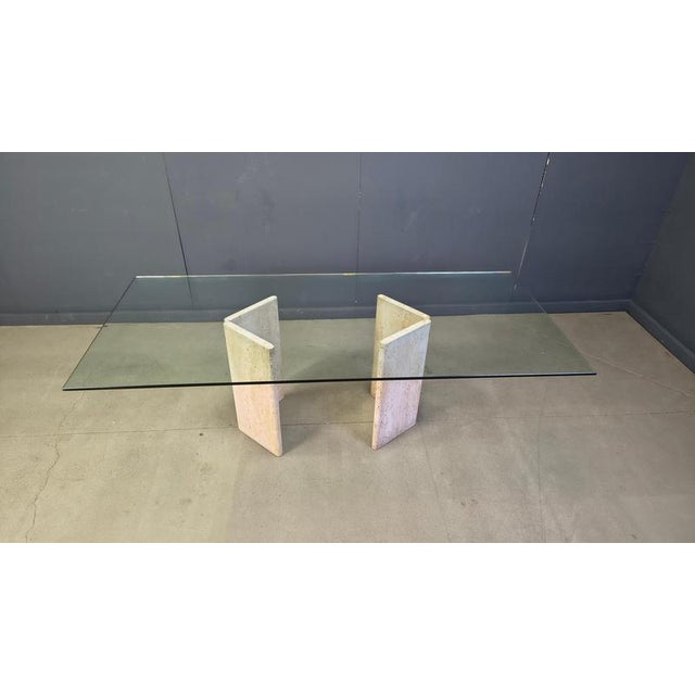 Timeless dining table feauturing a double Italian travertine base consisting of two beautiful natural slabs connected with...