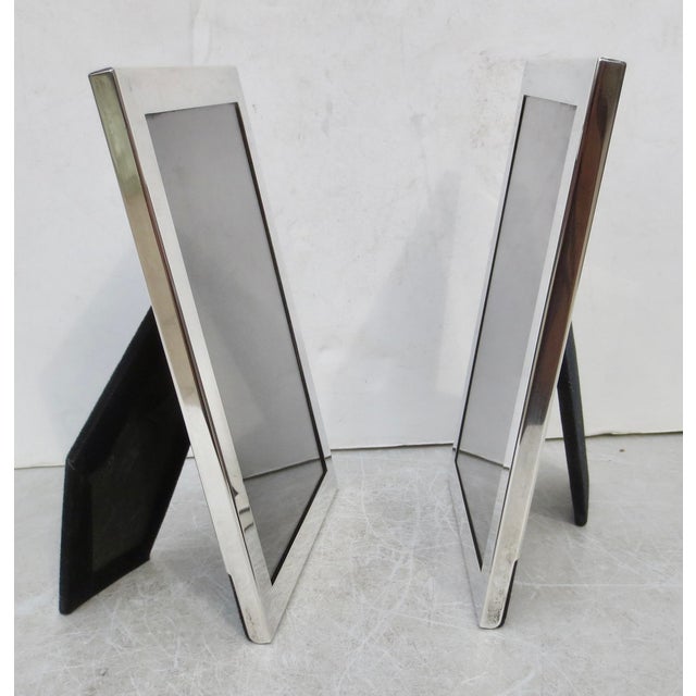Matching pair of sterling silver photo frames. Marked to the frame Reed & Barton Sterling. Measurements are 6" by 8"...