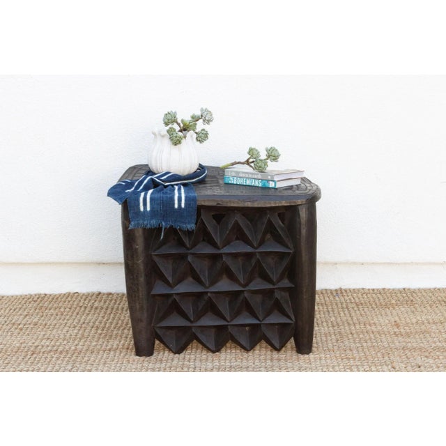 A stunning piece of African craftsmanship, this antique Nupe side table from Nigeria is hand-carved from a single piece of...
