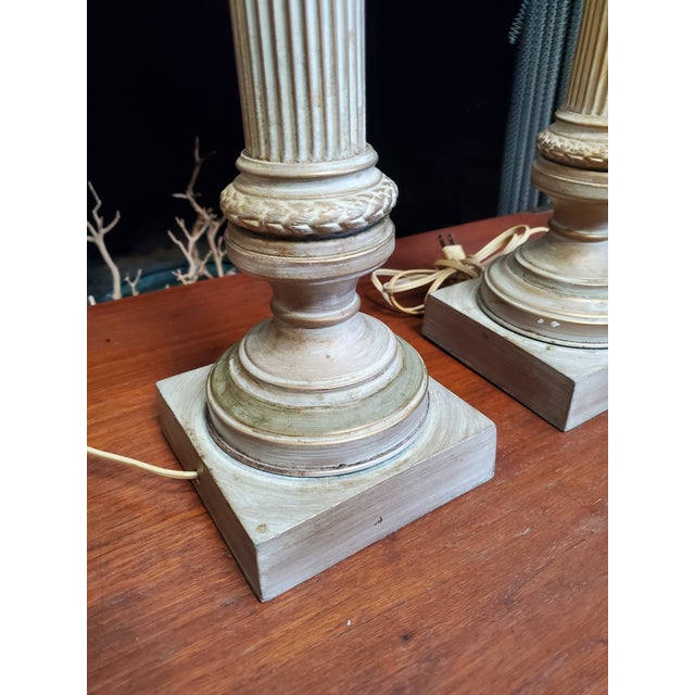 This listing is for a pair of metal Corinthian column table lamps, featuring a Neoclassical design inspired by ancient...