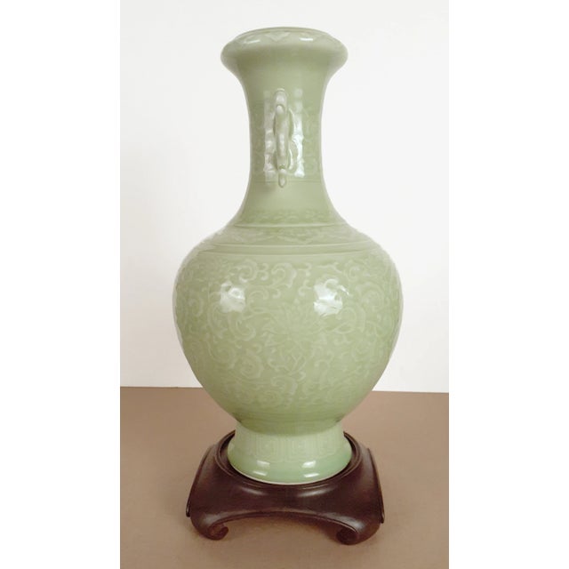 Chinese celadon floral haitangzun vase, a garlic headed vase, covered by a celadon glaze on the exterior and interior...