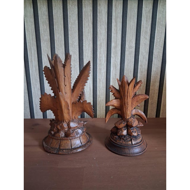 This pair of exquisite hand-carved sculpture is an authentic Black Forest (Schwarzwald) piece, crafted from fine linden...