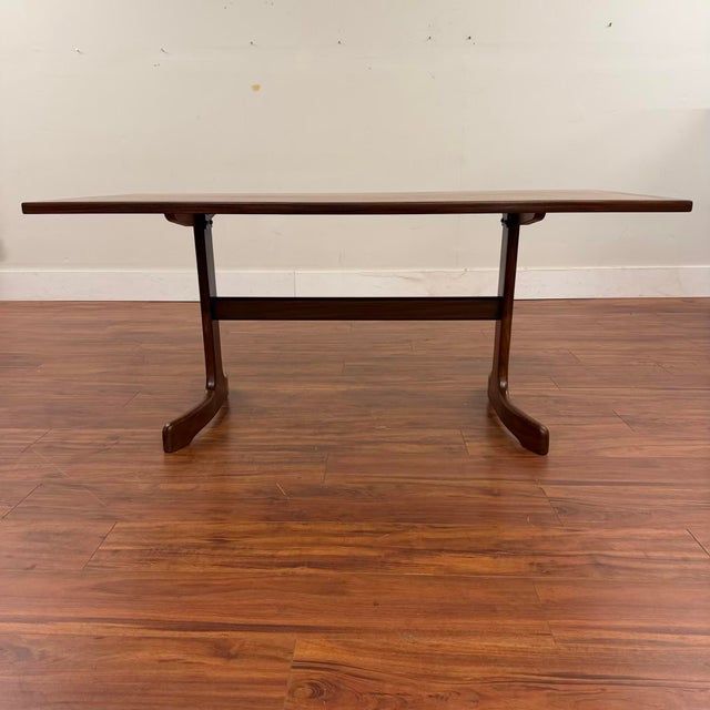 G-Plan vintage teak 'Whale Tail' dining table featuring a teak top with contrasting afromosia (African teak) trim and...