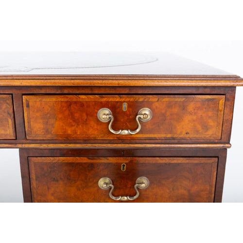 Impressive burr walnut Georgian style gentleman's desk This desk is raised upon bracket feet, featuring an arrangement of...