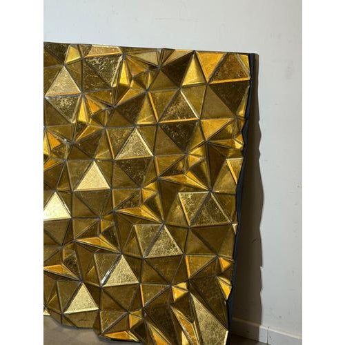 Impressive large sculptural wall mirror featuring a striking composition of faceted geometric panels finished in a rich...