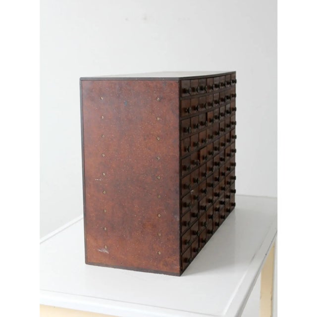 This antique phenolic resin tool chest offers 80 slender drawers for organizing small tools, hardware, or office supplies....