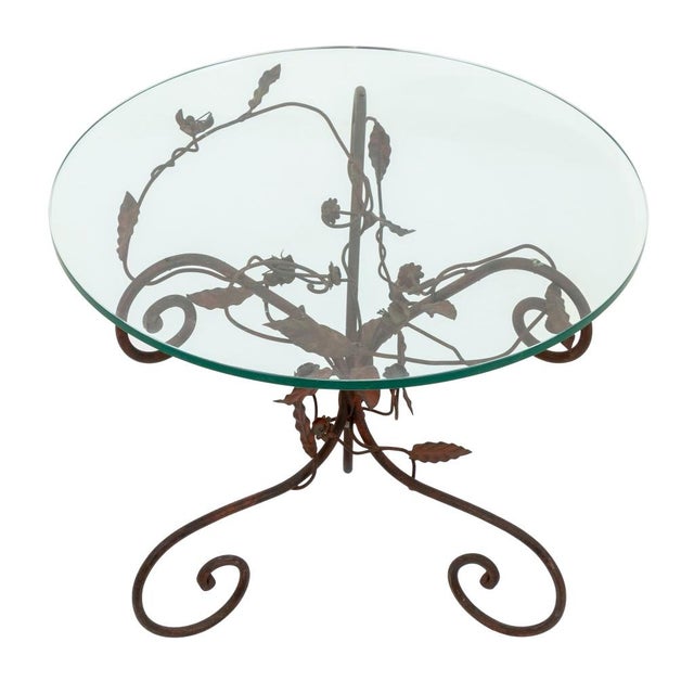 Glass-Topped Foliate Motif Red Painted Wrought Iron Side Table, circular glass top above three scrolled form supports....