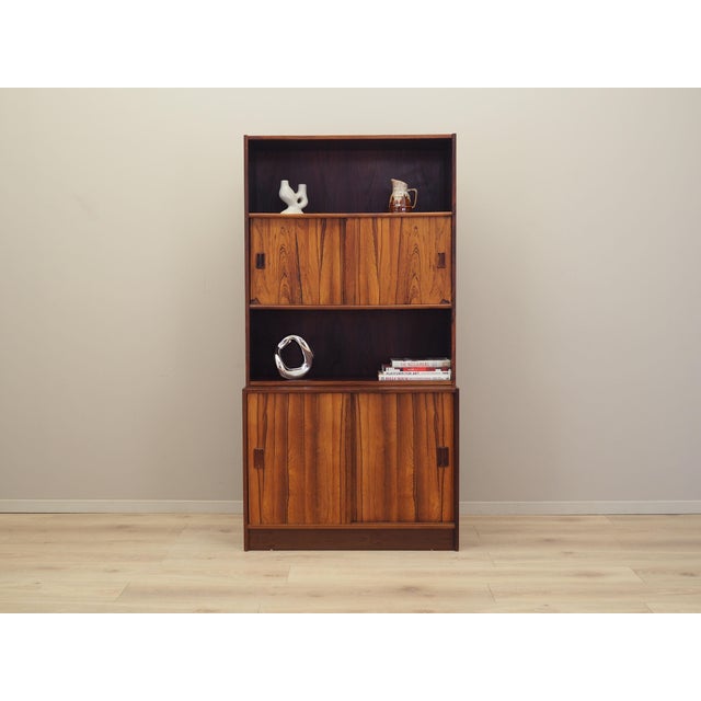 The bookcase was made in the 1960s, Danish production. The structure is covered with rosewood veneer. The furniture was...