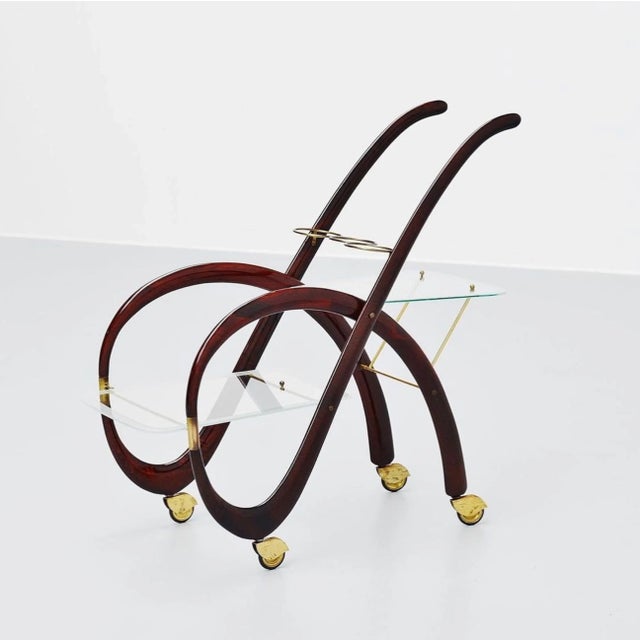 Esquisite organic shaped serving bar cart designed by Gaetano Pizzi, Italy, 1950. This cat has a solid mahogany frame with...