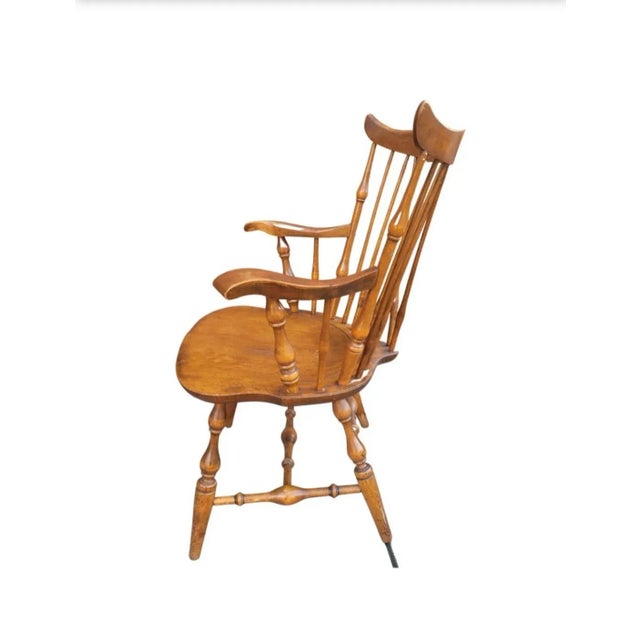 1960s Nichols and Stone Maple Fiddle Back Brass Back Windsor Armchair measuring 24" in width, 24" in depth, 36.75" in...