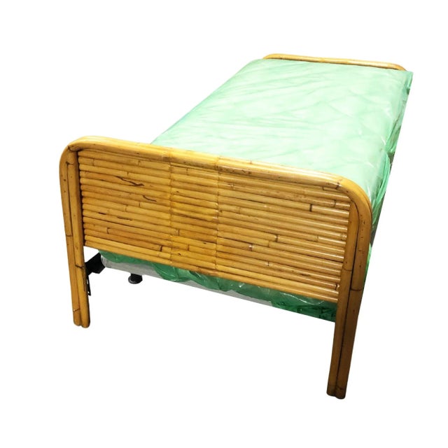 Pair of Mid-Century restored rattan bed frames. Mattresses not included. Two twin bed frames featuring a stacked rattan...